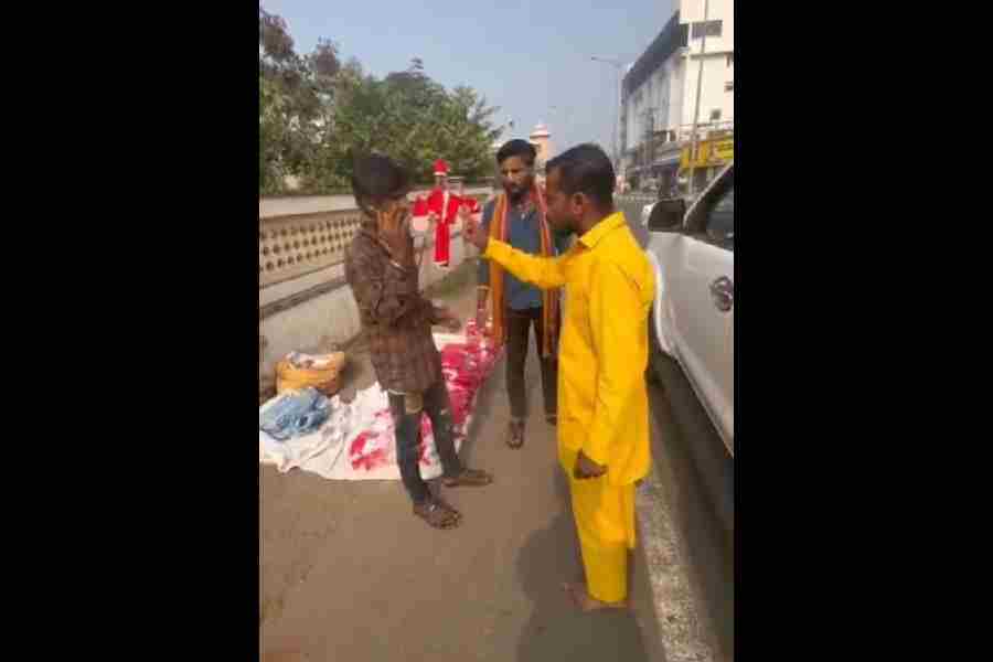 A screenshot from the video shows a vendor selling Santa hats being threatened in Puri