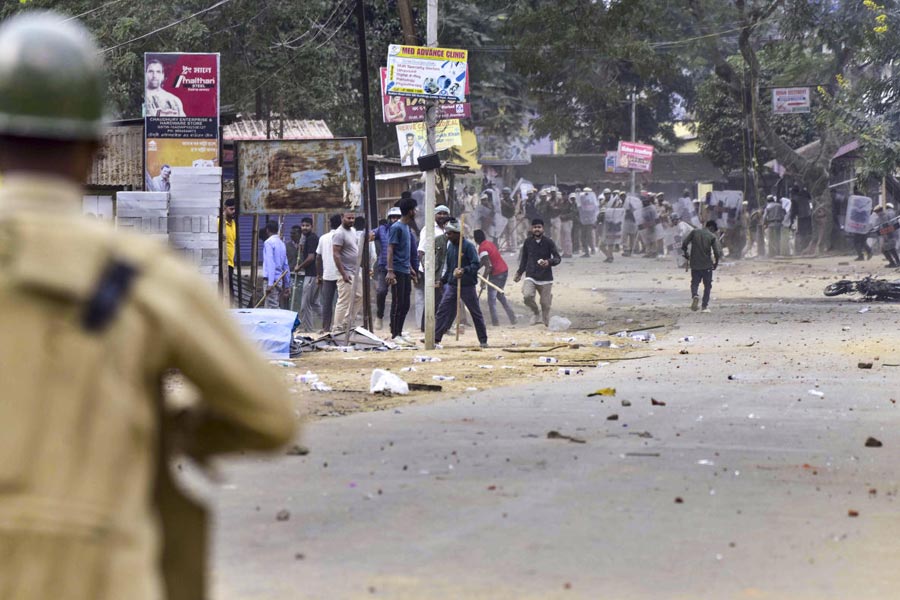 People throw stones during a clash between two groups over the issue of eviction, at Kheroni in West Karbi Anglong district, Assam, Tuesday, Dec. 23, 2025.