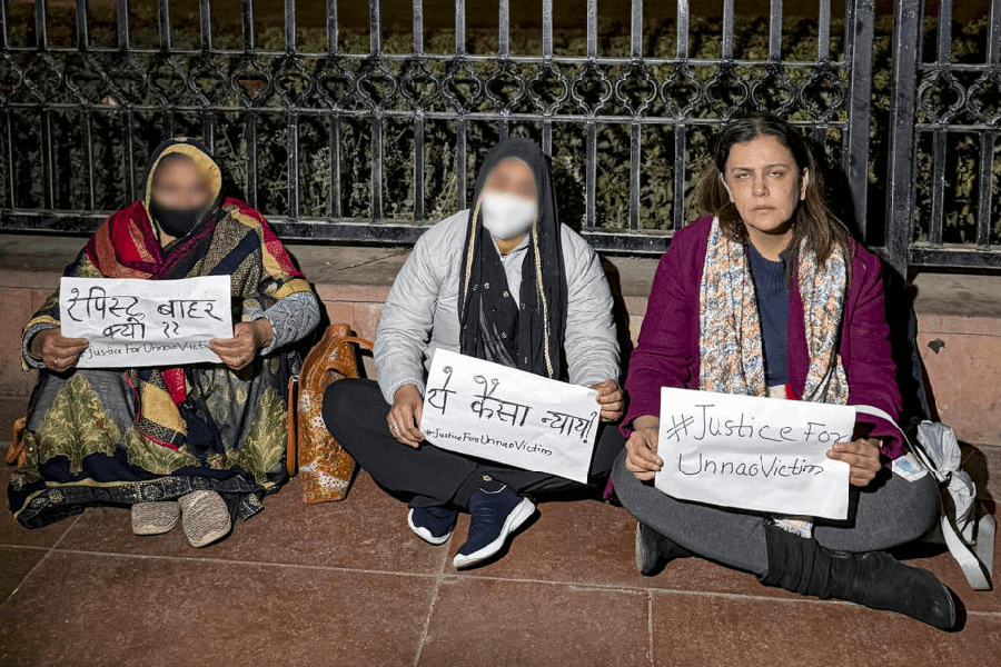 In this image received on Dec. 23, 2025, activist Yogita Bhayana stages a dharna with the family of the Unnao gang rape victim after the Delhi High Court suspended the jail term of expelled BJP leader and Unnao rape case convict Kuldeep Singh Sengar, near India Gate, in New Delhi.
