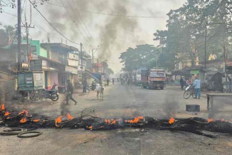 Protesters block a road in Chandbali with blazing tyres over the rape and murder of a minor
