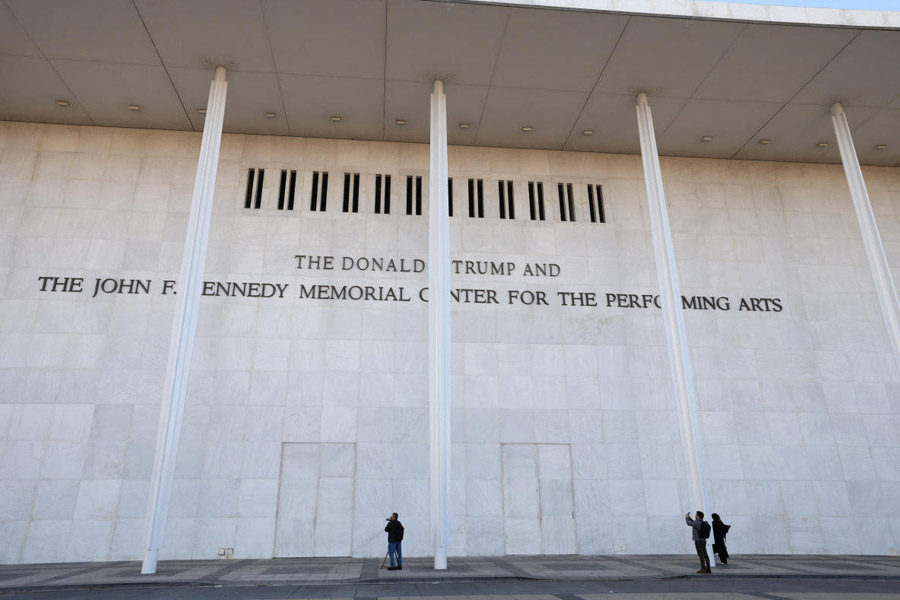 People stand outside the John F. Kennedy Center for the Performing Arts, with U.S. President Donald Trump's name added to its facade, a day after its board announced it would rename the institution The Donald J. Trump and The John F. Kennedy Memorial Center for the Performing Arts, in Washington, D.C., U.S., December 19, 2025.