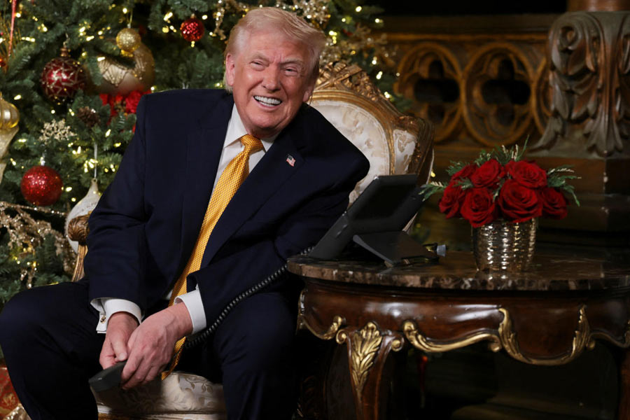 U.S. President Donald Trump participates in NORAD Santa tracker phone calls, on Christmas Eve, from the Mar-a-lago club in Palm Beach, Florida, U.S., December 24, 2025.
