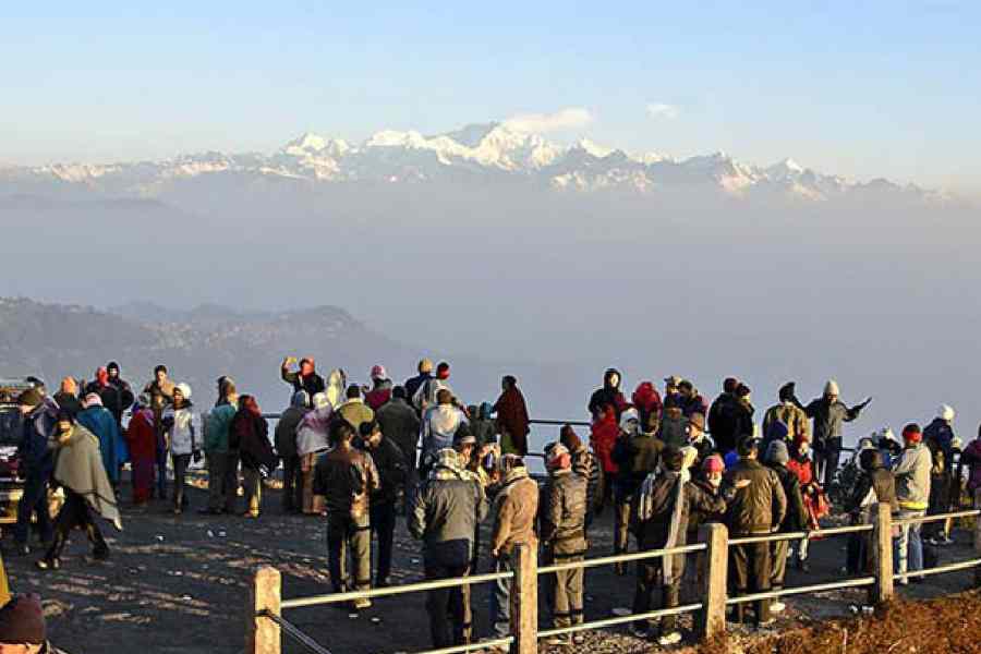 Tourists at Tiger Hill see the sun’s first rays breaking over the snow-capped peaks of the Kanchenjunga.