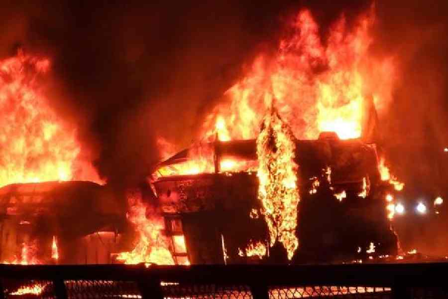 A bus engulfed in flames following a collision with a truck in Chitradurga, Karnataka, early on Thursday. 