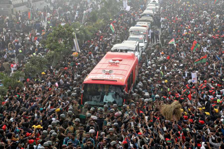 Tarique Rahman waves from a bus as his convoy negotiates a sea of people in Dhaka on Thursday.