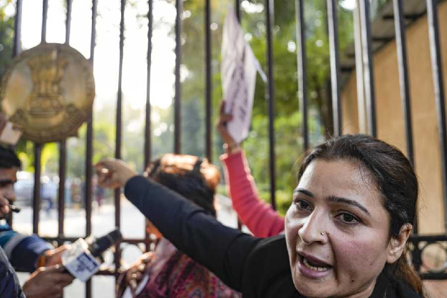 A protester raises slogans during a demonstration against the suspension of the jail term of Kuldeep Sengar, a former BJP MLA who was convicted in the Unnao rape case