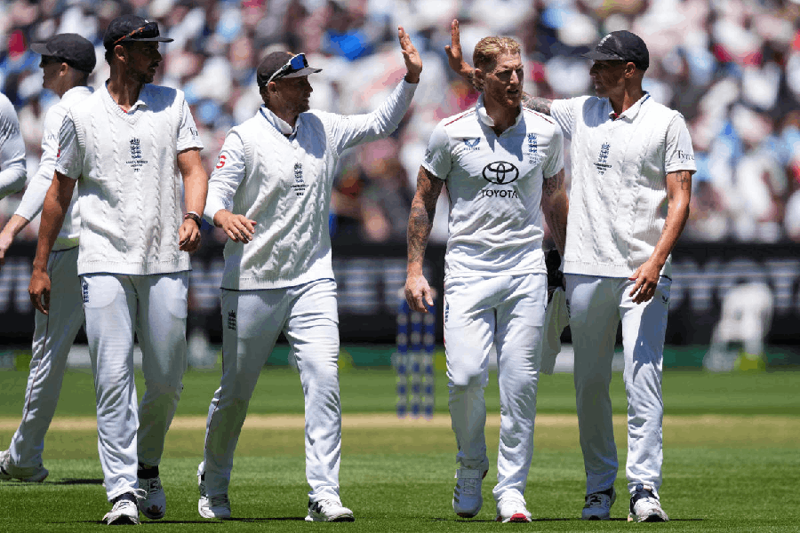 England's Josh Tongue, Joe Root, Ben Stokes and Brydon Carse celebrate after taking the final wicket of Australia's 2nd innings.