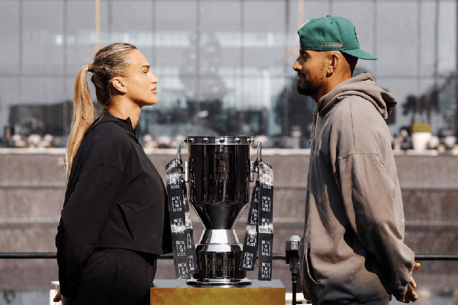 Nick Kyrgios and Aryna Sabalenka face-off with the trophy during the press conference.