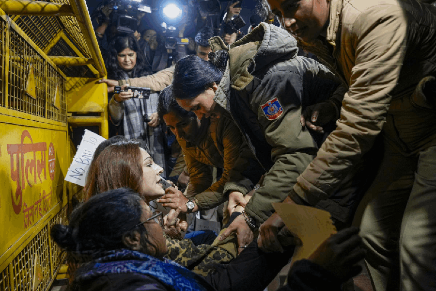 Police personnel remove activists and people sitting on a ‘dharna’ in protest seeking justice for the Unnao rape case victim, outside the Parliament House complex, in New Delhi, Saturday, Dec. 27, 2025.