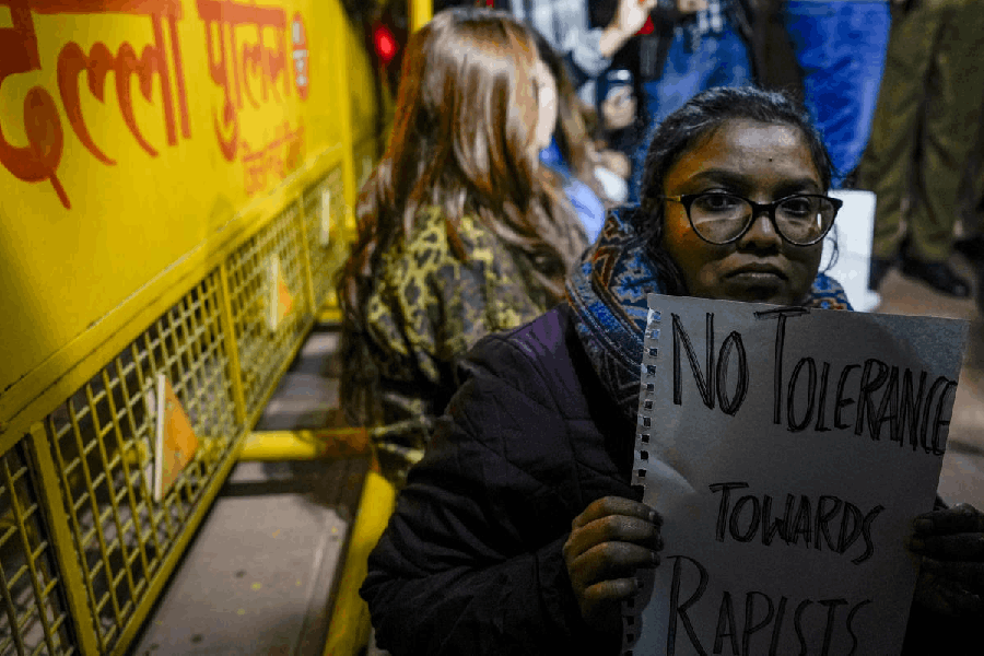 A woman holds a placard during a ‘dharna’ in protest seeking justice for the Unnao rape case victim, outside the Parliament House complex, in New Delhi, Saturday, Dec. 27, 2025.