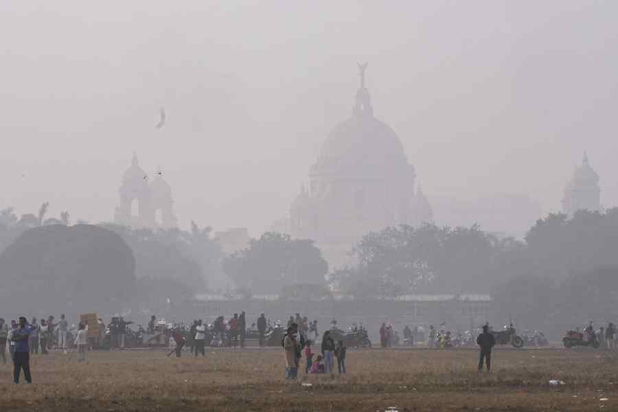 People take a stroll on a cold winter morning, in Kolkata, Sunday, Dec. 28, 2025.