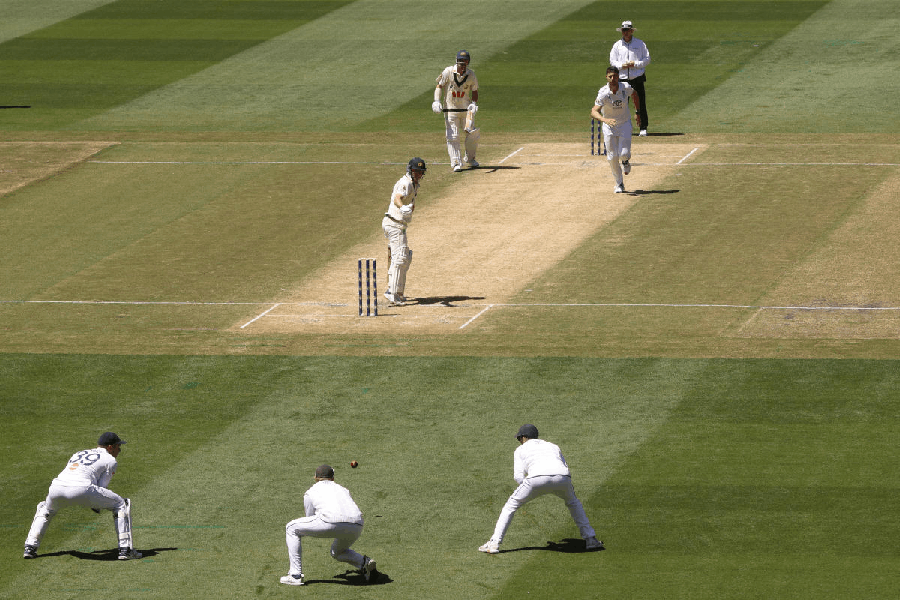 Australia's Marnus Labuschagne, center, turns to see England's Joe Root, second left, make a catch on Day 2 of their Ashes cricket test match in Melbourne, Saturday, Dec. 27, 2025.