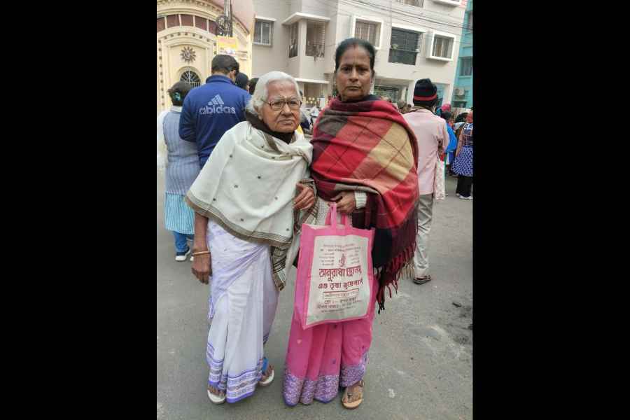 A senior citizen at an SIR hearing centre in West Behala along with a relative on Monday. Many had to wait in long queues for an hour before they were allowed entry.