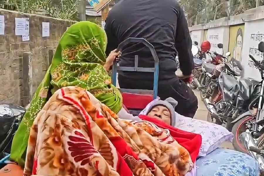 Bedridden and paralytic Rabindranath Roy being taken to the hearing centre at Gaighata, North 24-Parganas.