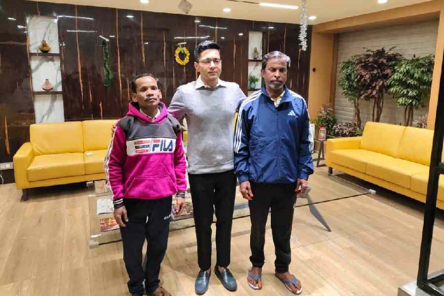Trinamool national general secretary Abhishek Banerjee with Asit Sarkar (right) and Gautam Barman at his Camac Street office in Calcutta on Sunday