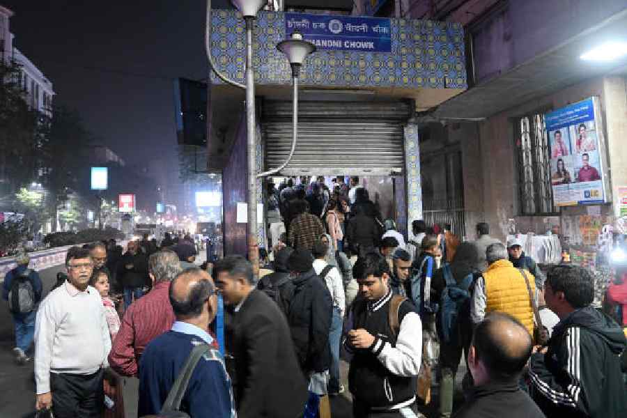 Passengers leave Chandni Chowk Metro station after services were suspended on Monday evening; (below) commuters wait for transport outside the station.            Pictures by Sanat Kr Sinha