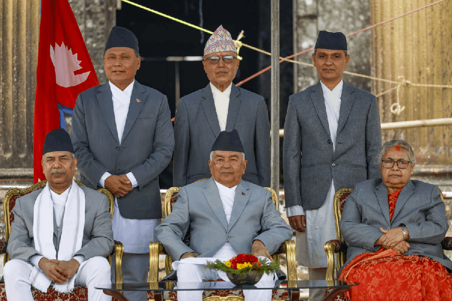 President Ram Chandra Poudel, center, Vice President Ram Sahay Yadav, second left, and Interim Prime Minister Sushila Karki, second right, along with the newly appointed ministers, pose for the photo after the swear-in ceremony at the premises of the president's residence, in Kathmandu, Nepal, Monday, Sept. 15, 2025.