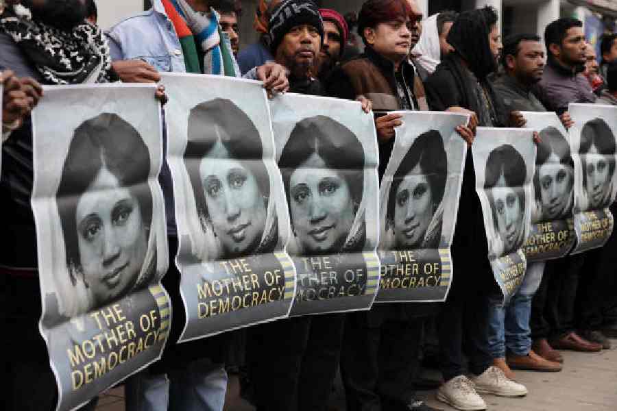 Supporters hold posters of Khaleeda Zia, in Dhaka on Tuesday.