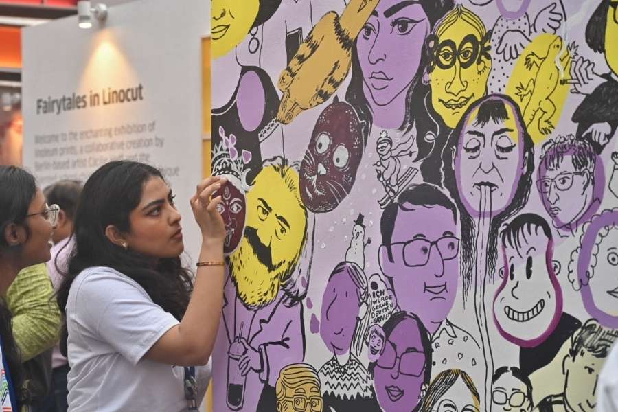 An amalgamation of Indian and German cultures — a young woman marvels at a mural featuring goddess Durga and Karl Marx, among others