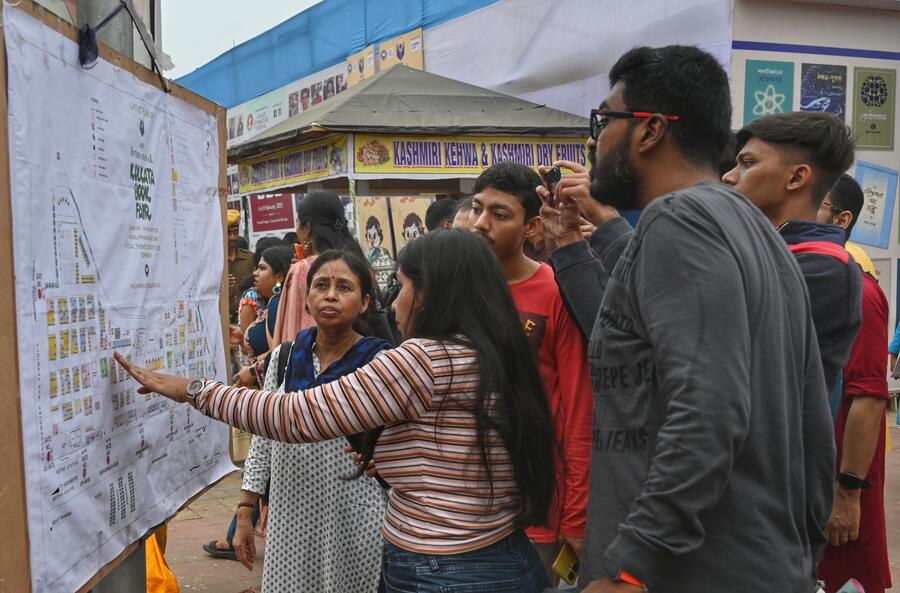 Visitors try to locate their preferred stalls on a giant map of the Book Fair ground. For the first time this year, the guide map is also available on an app that can be downloaded from the International Kolkata Book Fair website