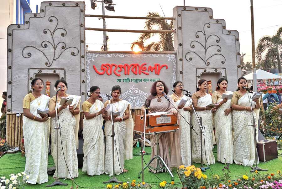 Women dressed in white saris perform on the ‘Jagobangla’ stage
