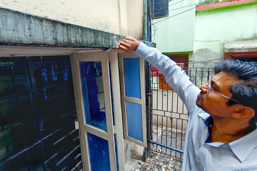 A member of the Geological Survey of India collect samples from the oil seep at the Sarkar house in Garia on Thursday. About a month ago, residents for almost 50 years of ward no 29 of Rajpur-Sonarpur Municipality, Ratan Kumar Sarkar (63) and Shampa Sarkar (54) complained that for the past two years, the pillar on the left of the house has been spilling oil
