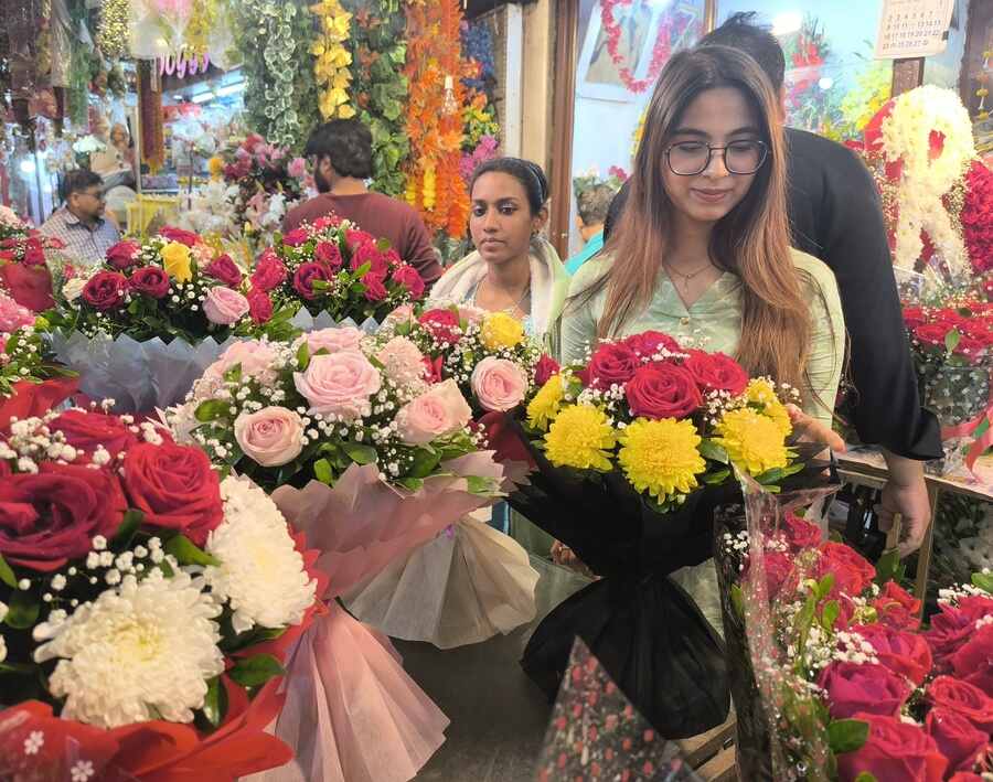 Customers choose pretty bouquets for Valentine’s Week at the flower range in New Market on Friday