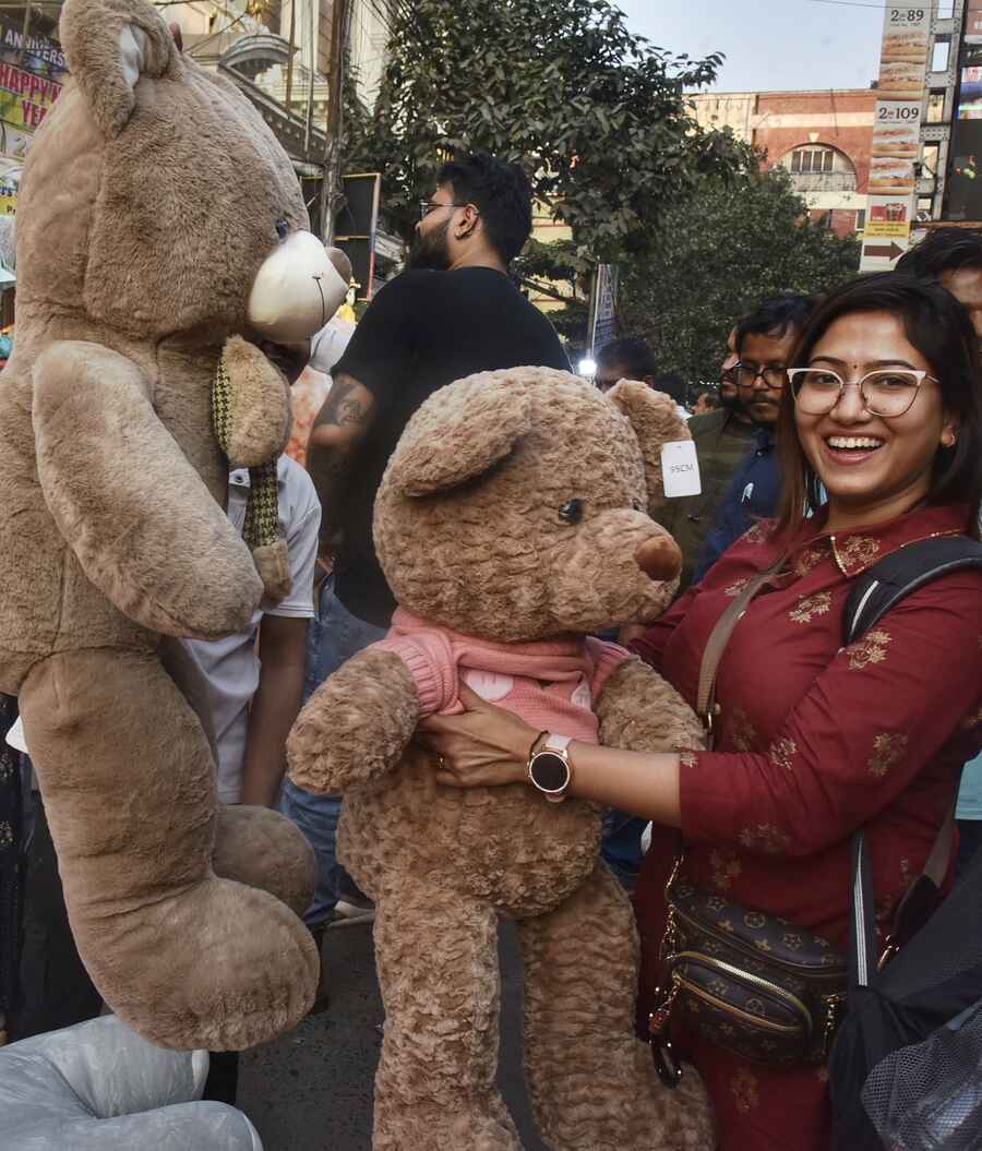 A giant teddy bear has a shopper all smiles at New Market on Teddy Day on Monday ahead of Valentine's Day