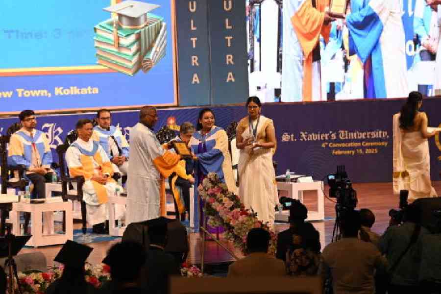 Father Felix Raj, vice-chancellor of St Xavier’s University, presents a degree certificate to a student during the institute’s convocation at the Biswa Bangla Convention Centre in New Town on Saturday. Pictures by Bishwarup Dutta