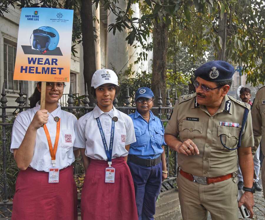  Kolkata Police commissioner Manoj Kumar Verma interacts with school students, carrying placards calling upon bikers to wear helmets, at BBD Bag on February 11. Kolkata Traffic Police are observing a road safety week till February 15  