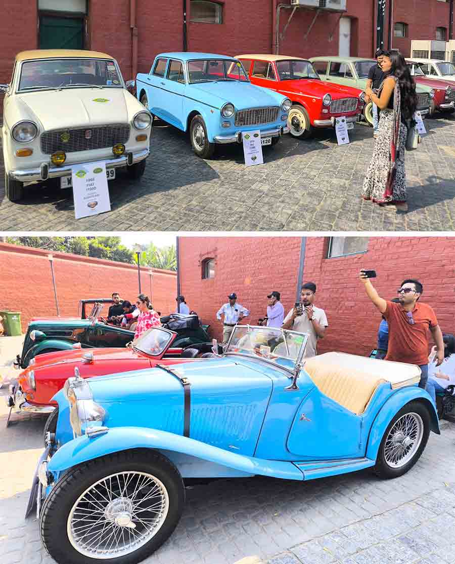 A lady admires the classic looks of the Premier Padminis and Presidents on display, while these gentlemen were hard at work trying to get the best possible angles for their photographs of this two-seater MG TC with a bright blue chassis and white interiors. The analogue odometer of the open-hooded car was a sight worth capturing