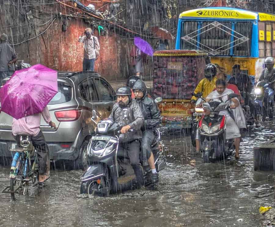 Commuters and vehicles found it difficult to negotiate the inundated railway underpass near Dum Dum station 