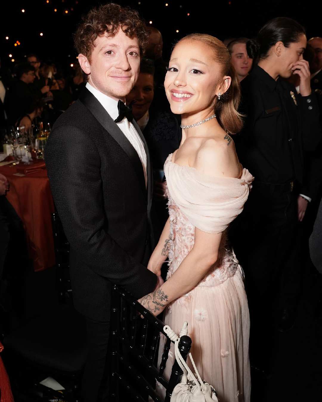 Wicked stars Ariana Grande and Ethan Slater posed for a picture. Slater sported a crisp suit while Ariana stunned in a pink off-shoulder dress.  
