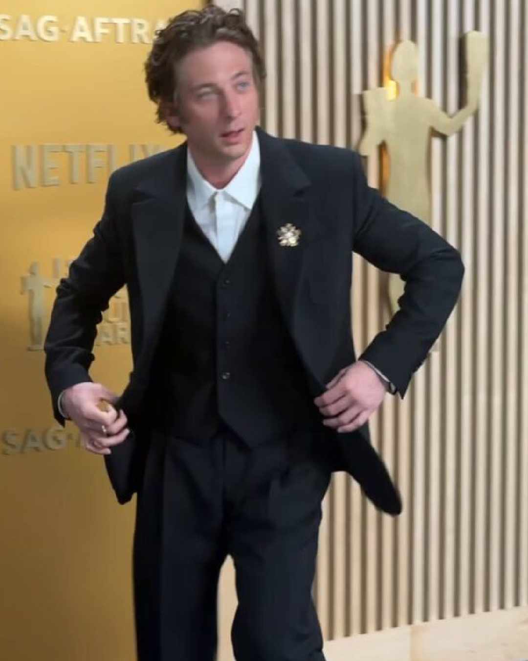 Jeremy Allen White looked stylish in a black three-piece suit comprising a sharp blazer, a button-up vest and flared pants. 