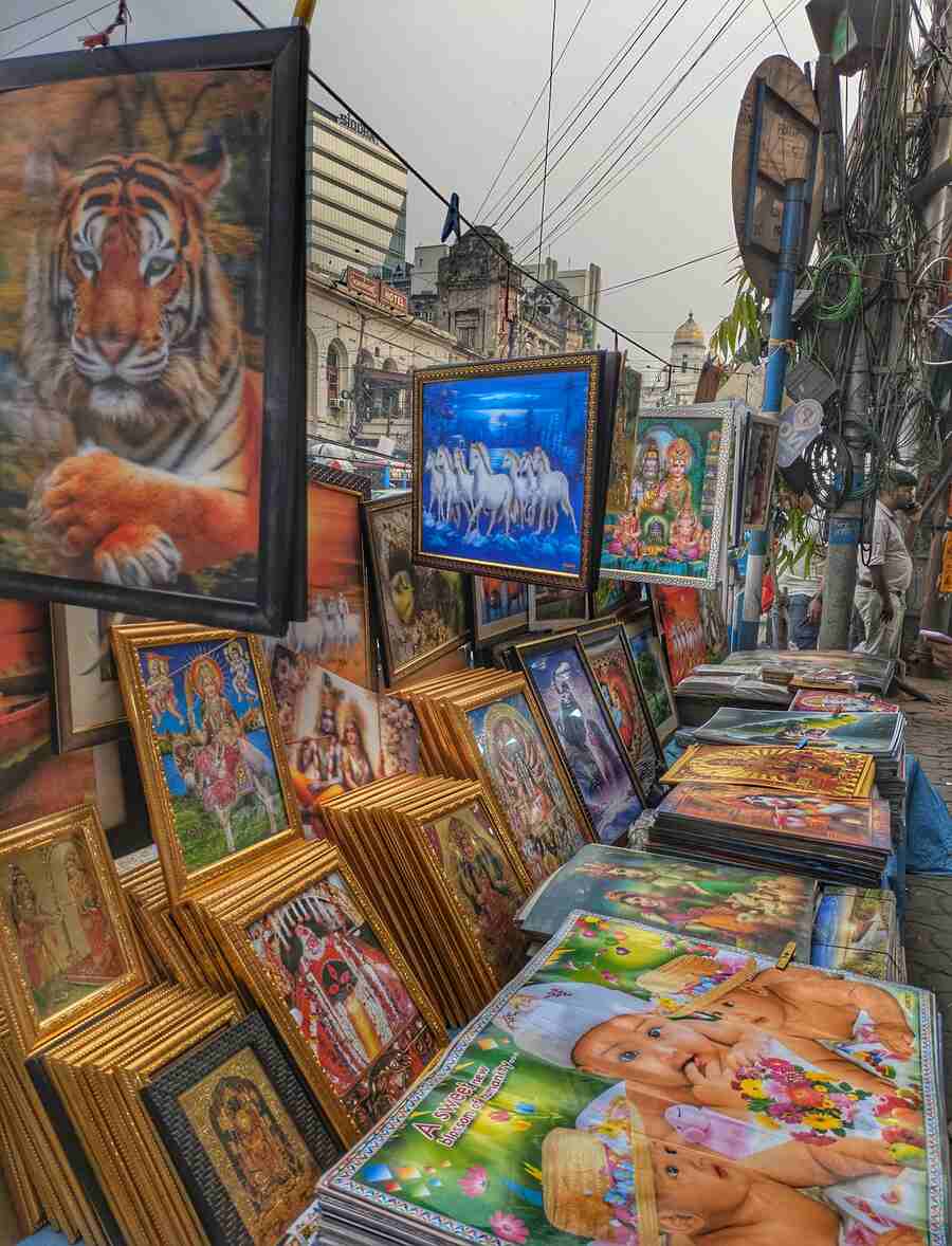 A hawker stacks up 3D photo frames for sale at Esplanade crossing 