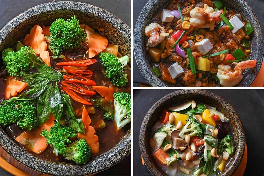 The dishes on the menu arrive in a stone pot or on a sizzler plate. The rice and noodle section features options like Hokkien Noodles — a spicy Fujian-style dish with a broccoli and carrot gravy, flavoured with basil and chillies. There’s also Butter Pepper Garlic Noodles with prawns and chives. For rice lovers, the menu includes fragrant stewed jasmine rice with vegetables and garlic pods. All noodle and rice dishes are served piping hot in stone bowls