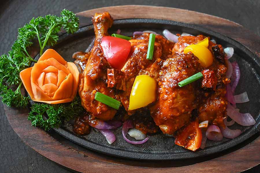 The non-vegetarian sizzler menu has six options. Chicken lovers can try the classic Chicken Sizzler with assorted peppers or the juicy Pot Roast Chicken with smoked chilli sauce (in picture)