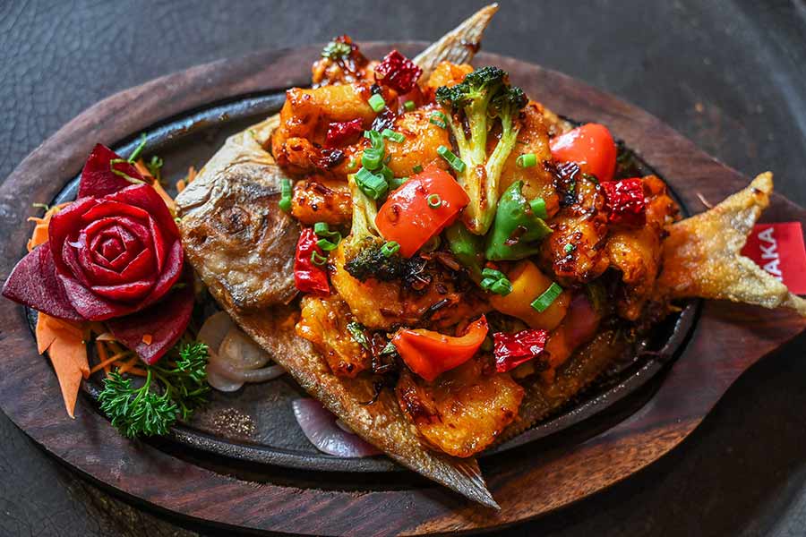 The seafood saga doesn’t end there! The menu also features a grilled Burnt Chilli Pomfret, served whole on a sizzling hot plate and topped with sautéed veggies, prepared in a special sauce
