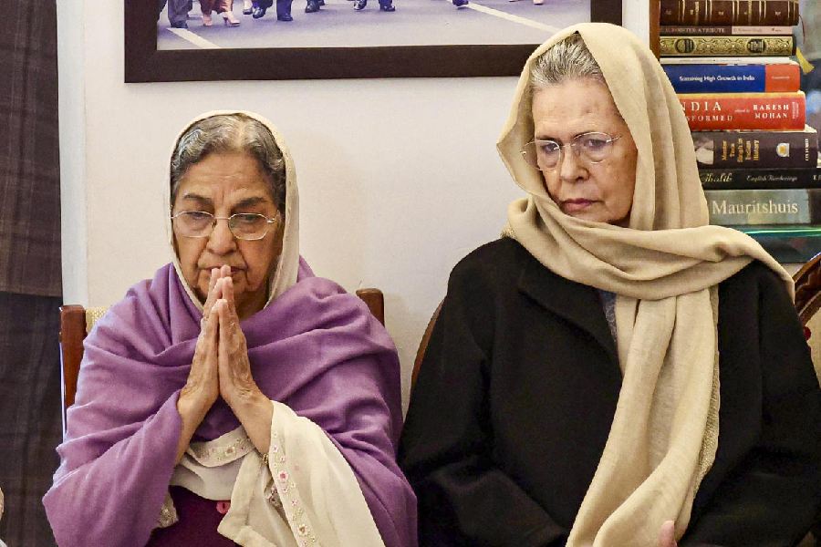 Sonia Gandhi with Gursharan Kaur, widow of Manmohan Singh. PTI