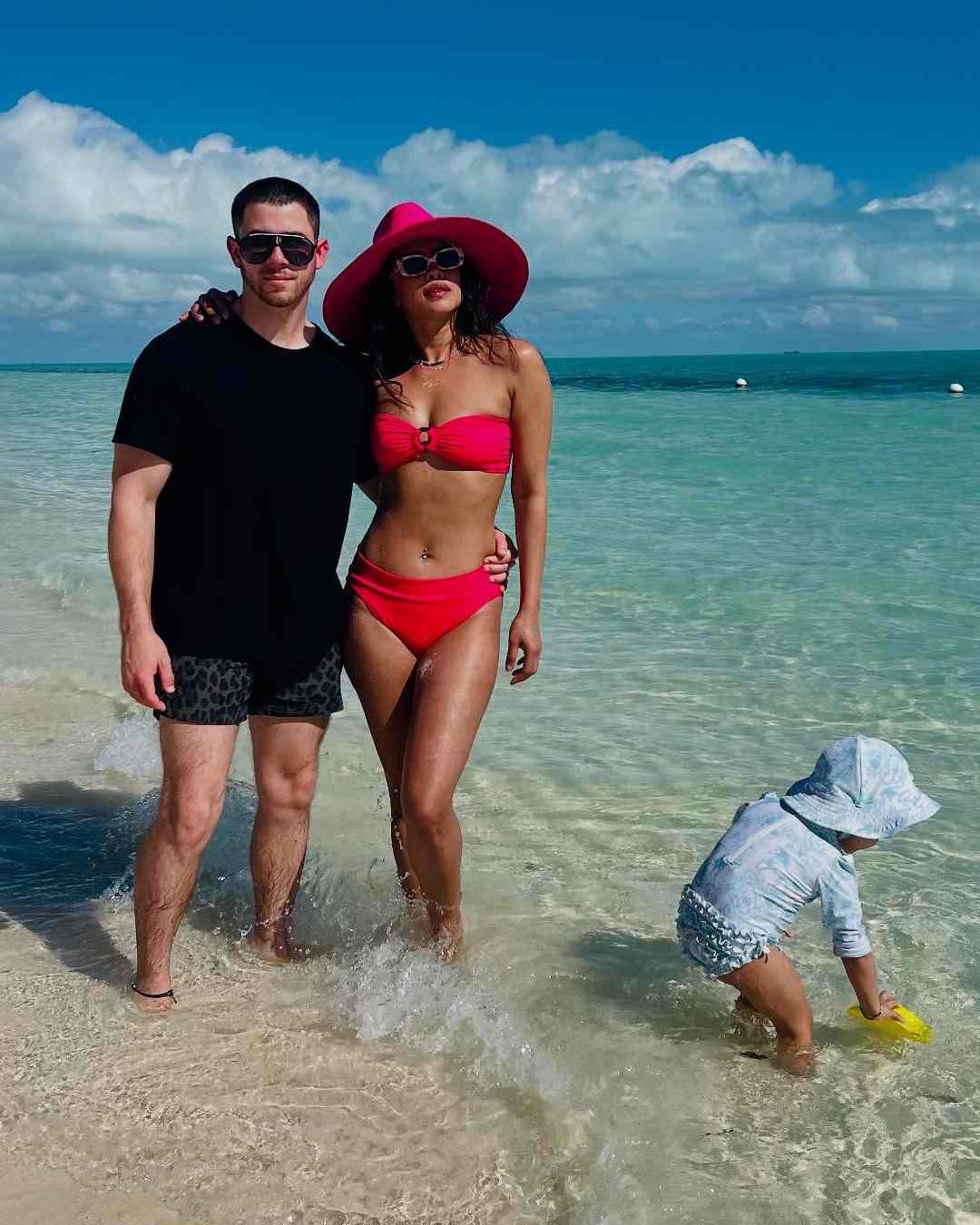 A pink bikini with a matching beach hat made for a cool beach look. 