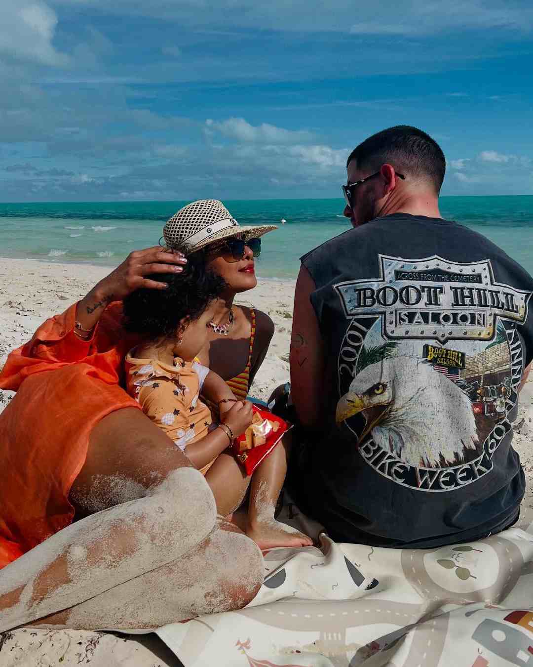 Priyanka, Nick and Malti savour the balmy ocean breeze on the sandy shores of the island.  