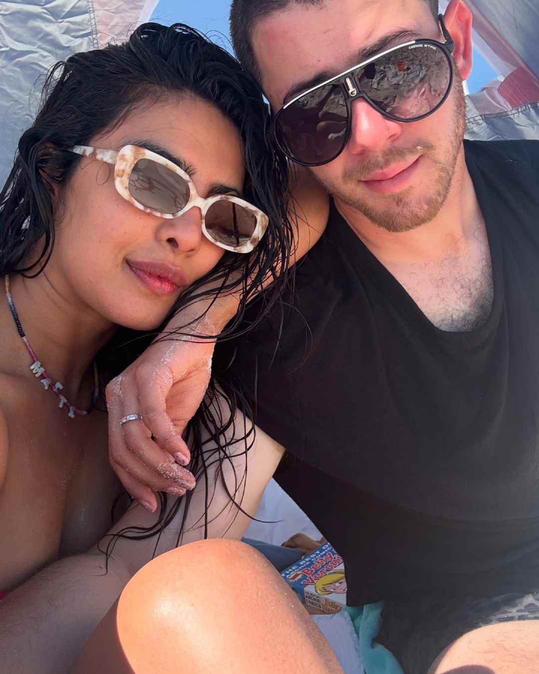 Priyanka and Nick pose for a selfie in chic shades after a dip in the ocean. 