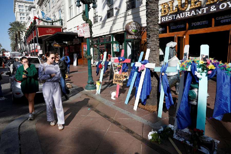 Mourners at the wooden crosses bearing the photos of the victims. 
