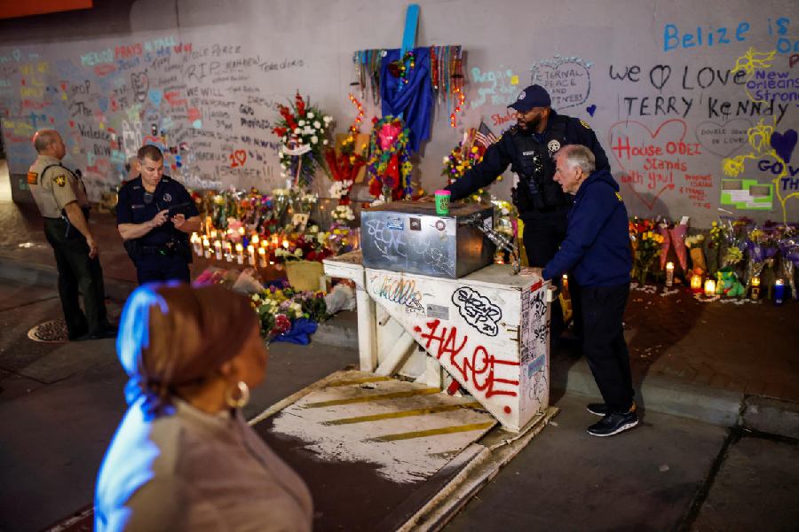 Police officers set up a barricade to block traffic driving along Bourbon Street.