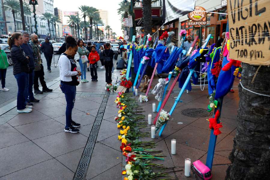 People pay their respects to the victims. 