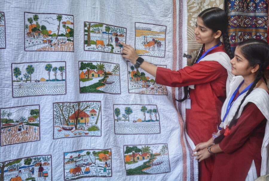 Two students check out ‘kantha’ stitch embroidery at Park Circus Milon Mela on Saturday