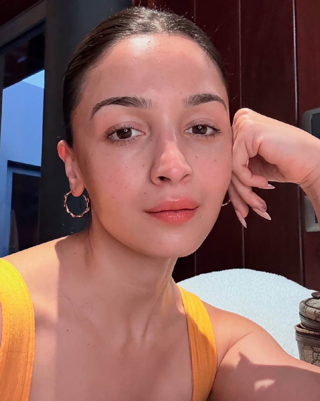 Alia Bhatt looked gorgeous in a sleeveless orange dress, minimal makeup and golden hoop earrings. She is set to share screen space with husband Ranbir Kapoor in Sanjay Leela Bhansali’s Love & War.