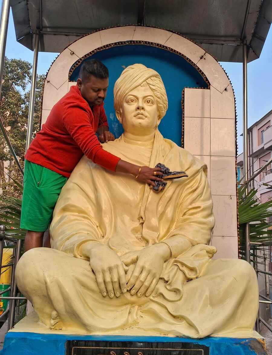 A man cleans the statue of Swami Vivekananda in Ahiritola ahead of his 162nd birth anniversary on January 12