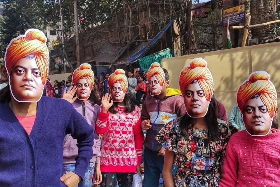 Children sport Vivekananda masks in a procession at Pathuriaghata on Sunday. The students also participated in a sit-and-draw competition   