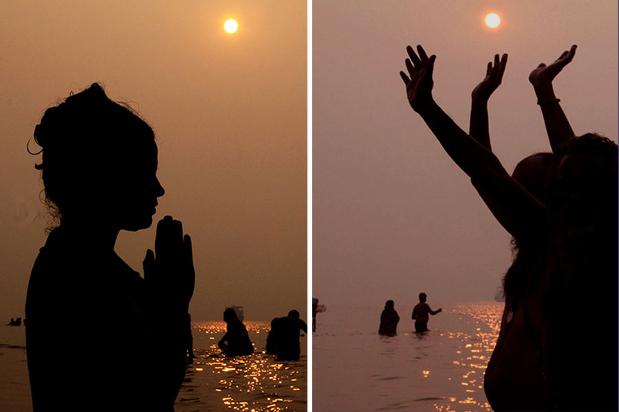The silhouette of pilgrims against glistening waters of the Ganga and the rising sun provide the perfect photographic capture at Sagar Island on Tuesday morning